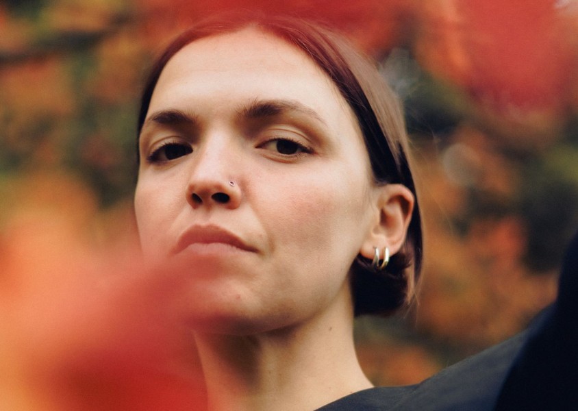 A woman with short brown hair and two silver hoop earrings in her earx